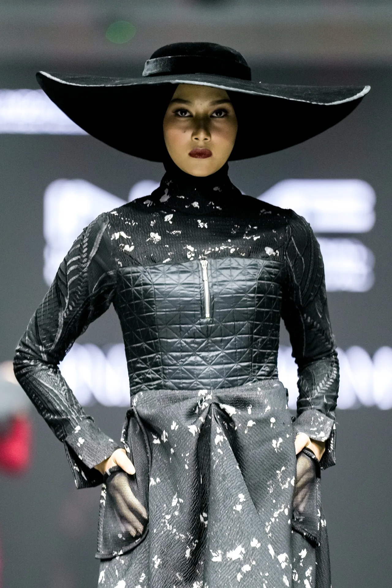 Gina in a sculpted black runway look